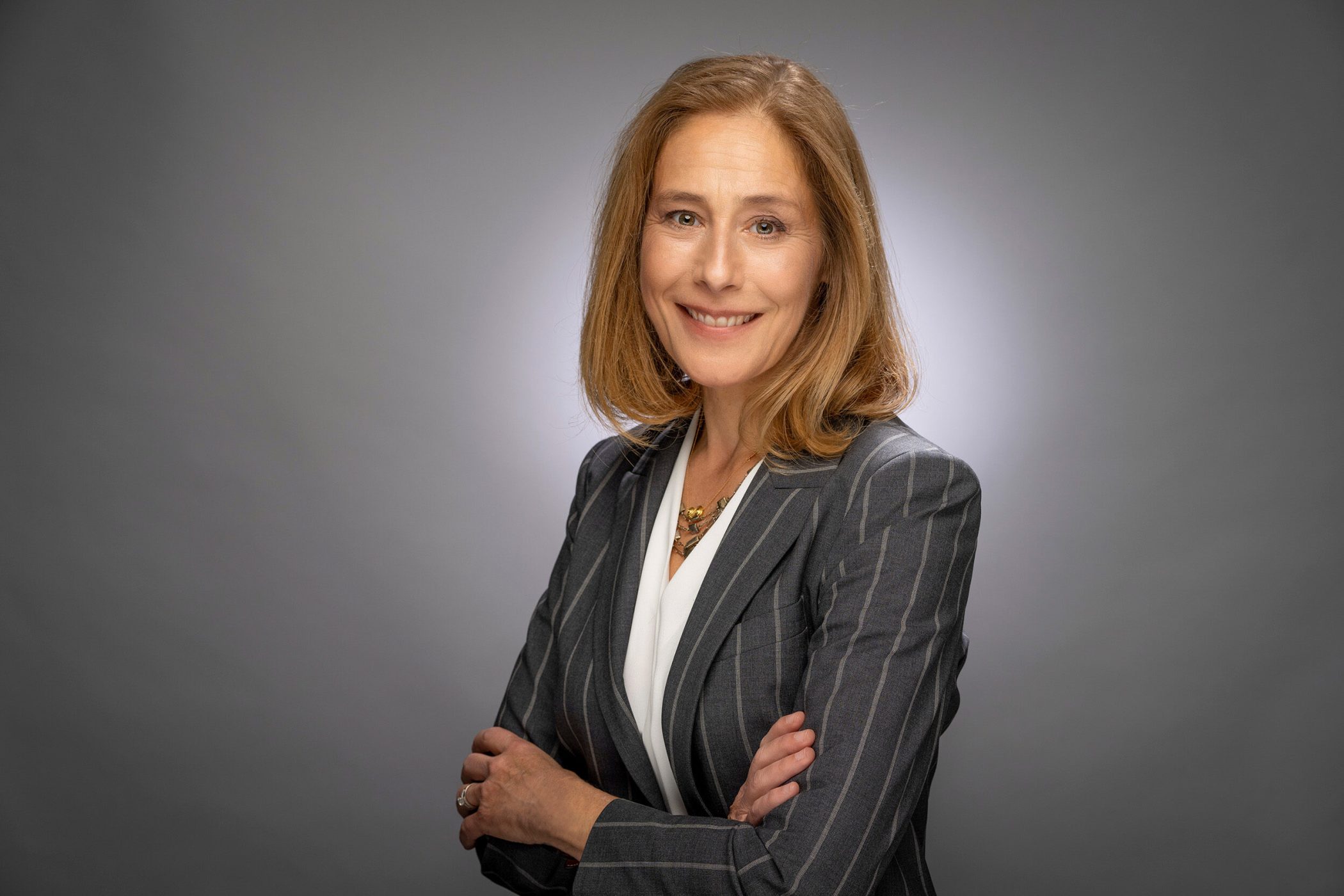 head and shoulders shot of woman with arms folded