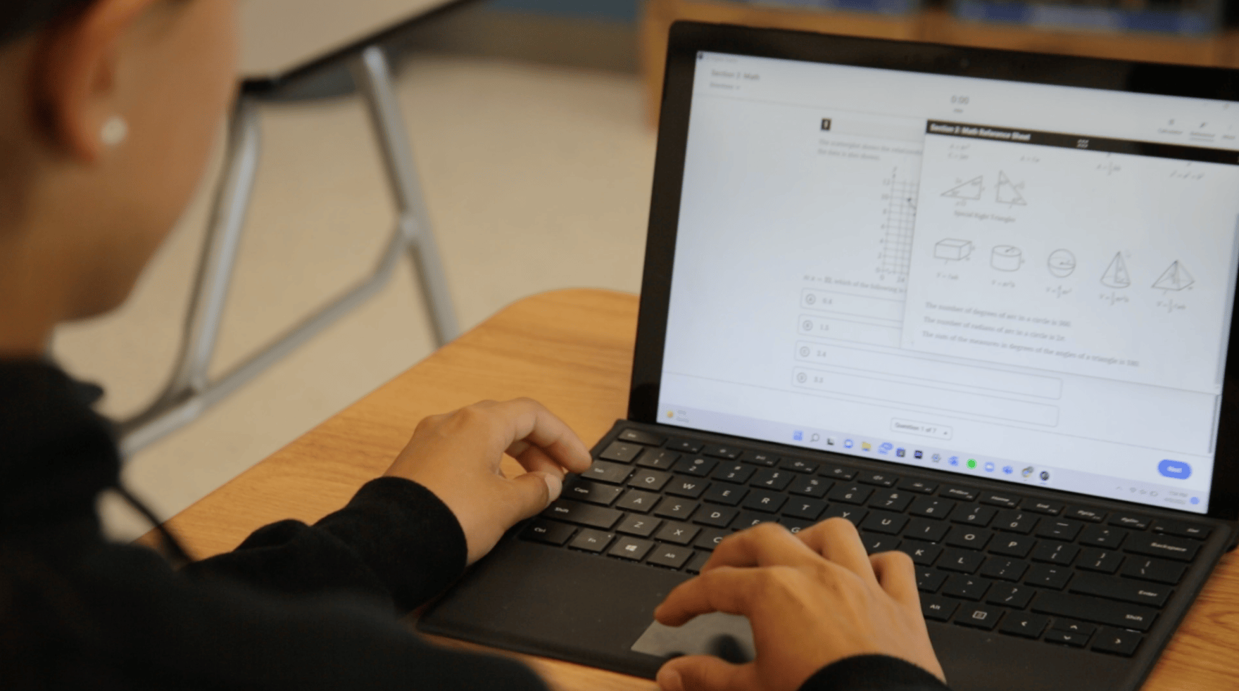 a student on a laptop taking a practice SAT exam with geography question on the screen