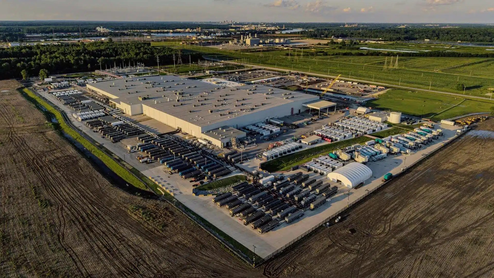 Aerial view of the Colossus 2 data center under construction by xAI in Memphis, showing large warehouse structures and surrounding infrastructure.