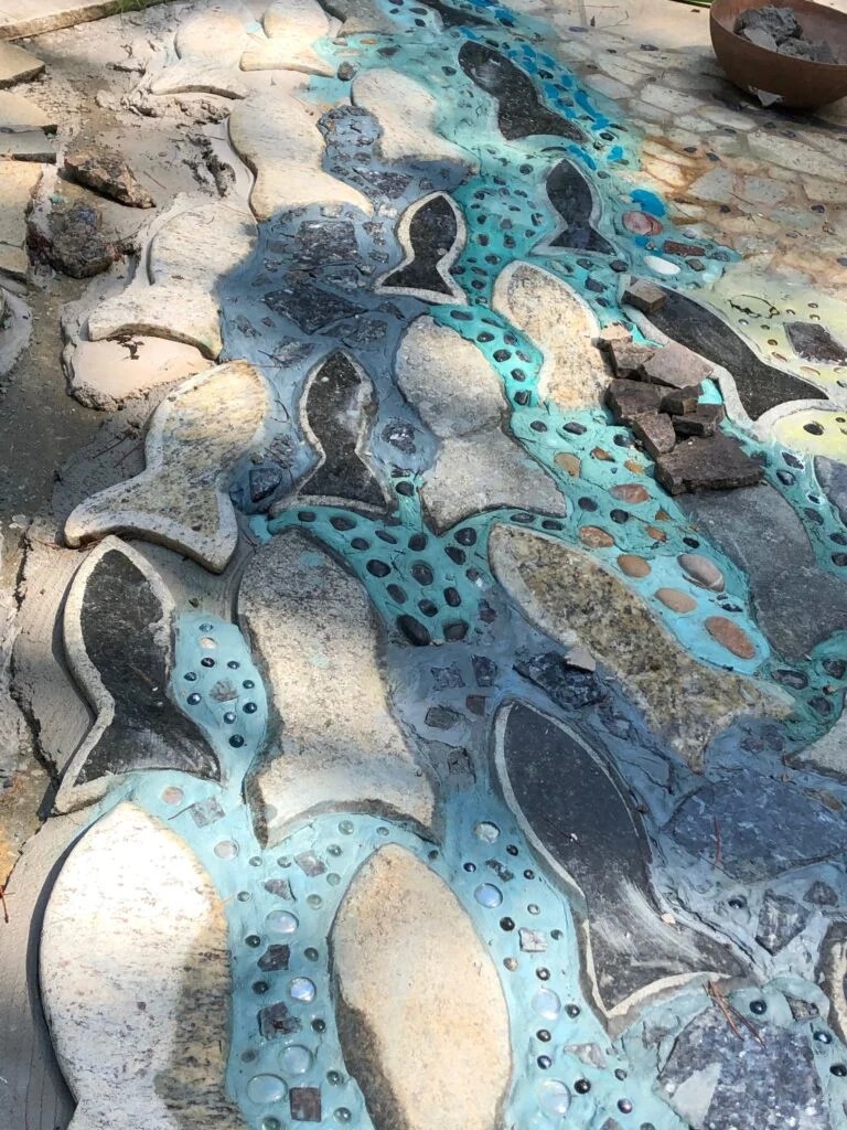 Stone fish and blue mosaic water detail in the Mosaic Driveway by Bruce Bennett and Allison Roberts at Spring Creek.
