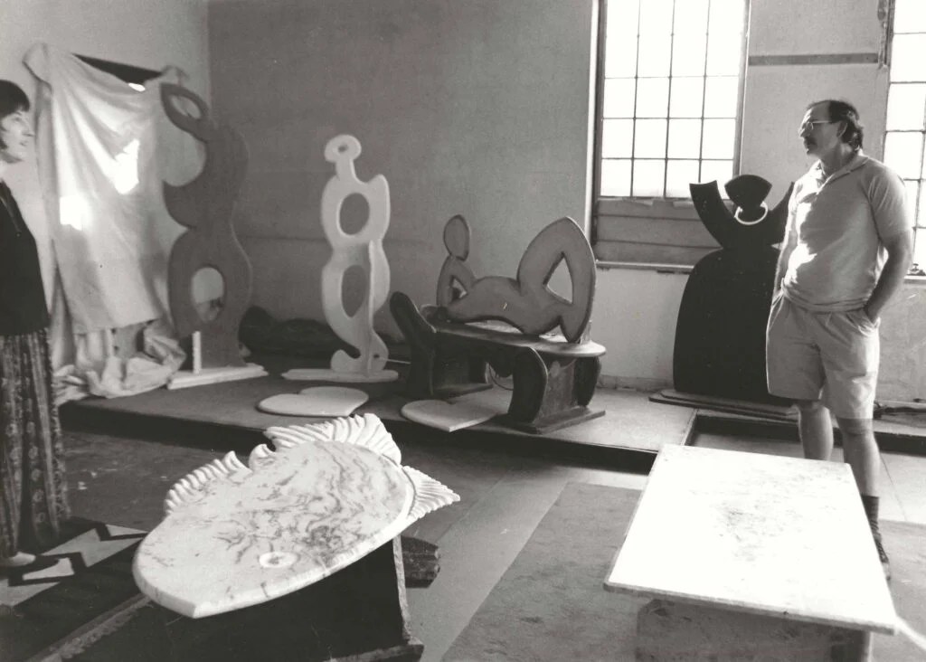 Bruce Bennett and Sandy Leach at the Candoro Marble building with Bruce's abstract figures. 1992