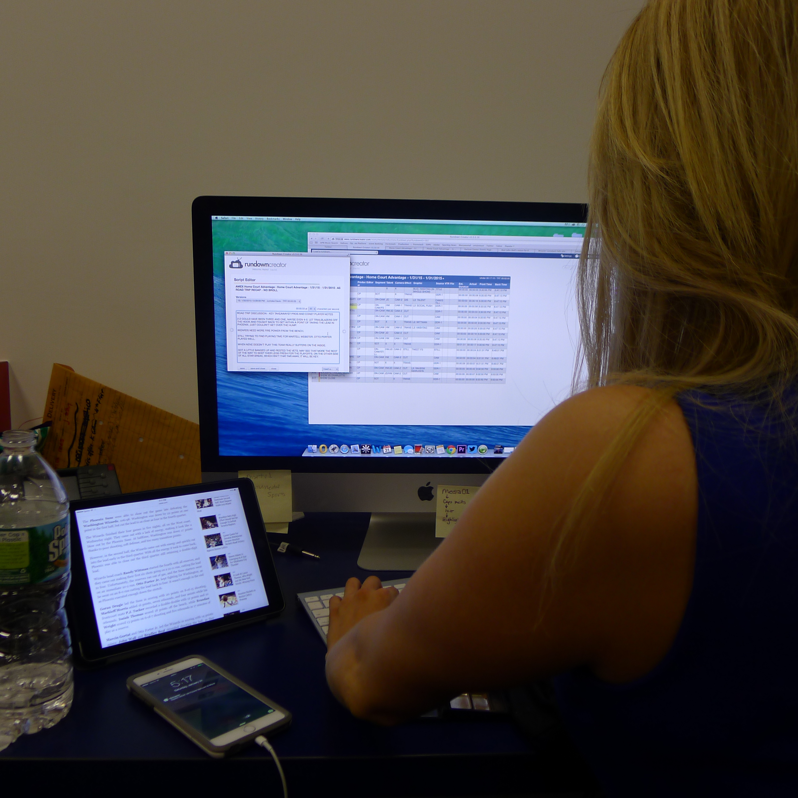 Hayley Milon editing the script for that night's episode of American Express Home Court Advantage pre-game show