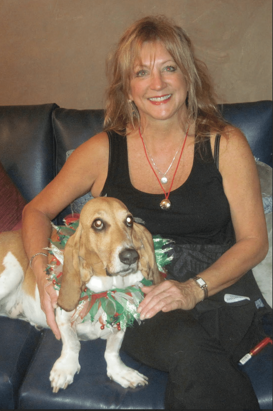 Temple Member Francis sitting with her Basset Hound Sunny on a sofa