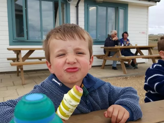 pulling a face while eating ice cream
