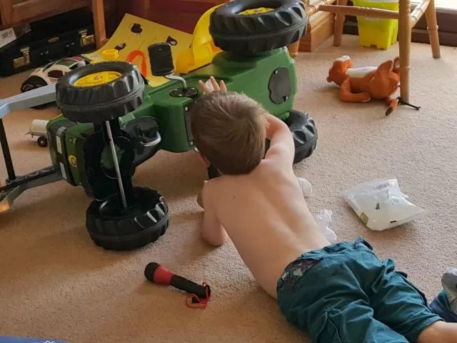 fixing his John Deere tractor