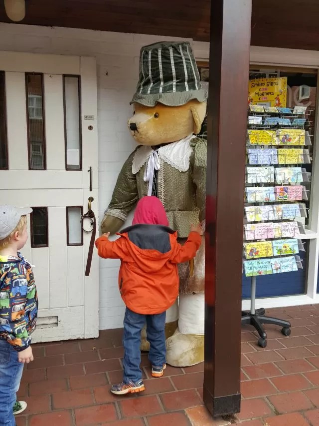 hugging the giant teddy bear
