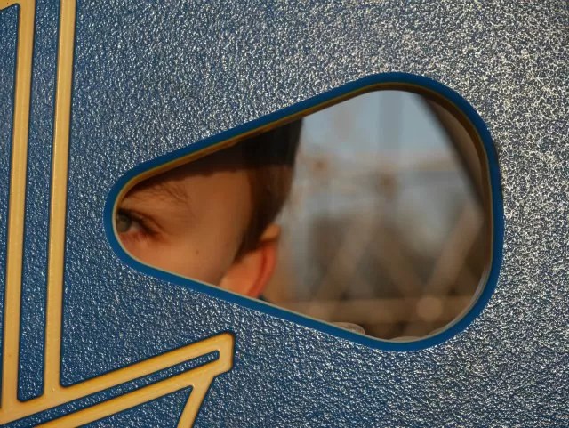looking through the hole at the playground