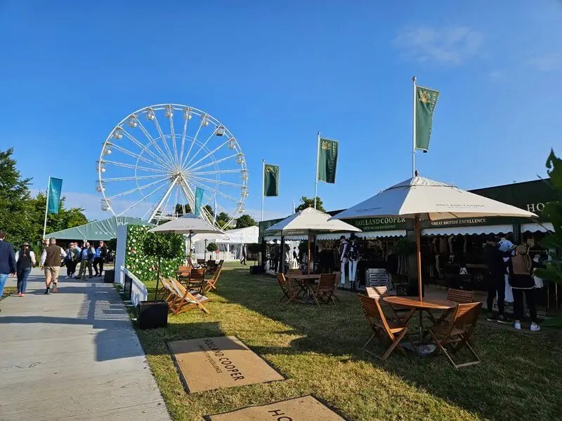 empty game fair stands with big wheel behind