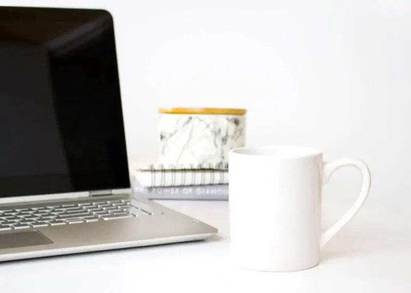 computer with mug of hot drink