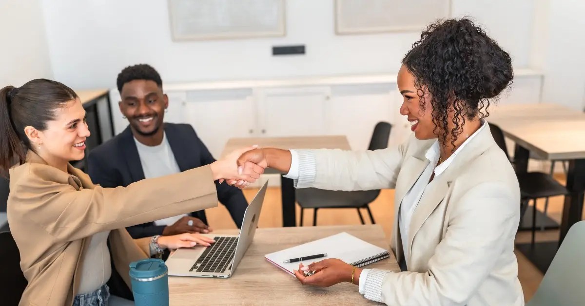 couple shaking hands with their mortgage broker