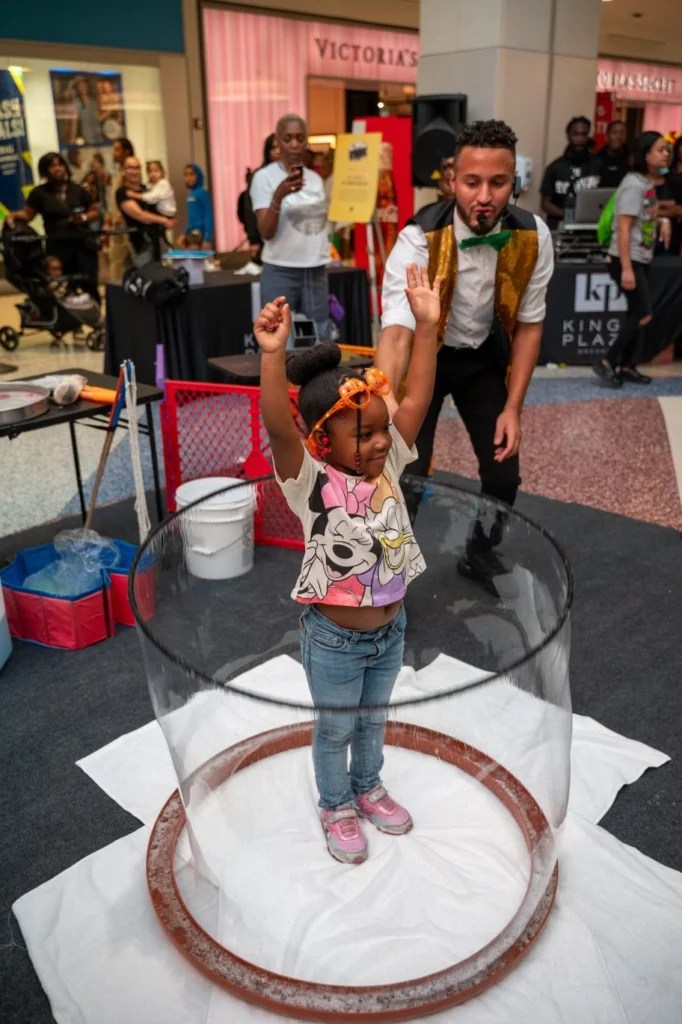 Girl inside a giant bubble at a shopping mall event