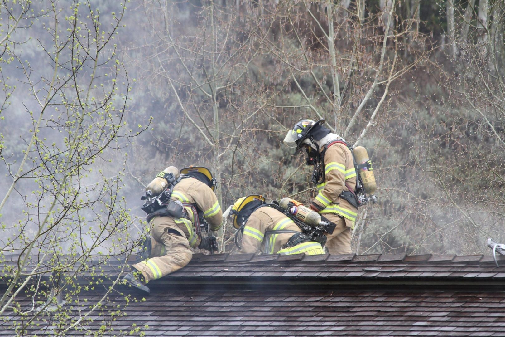 Firefighters bust open a hole in the roof to better combat the blaze. (Renee Schaiman Glick)