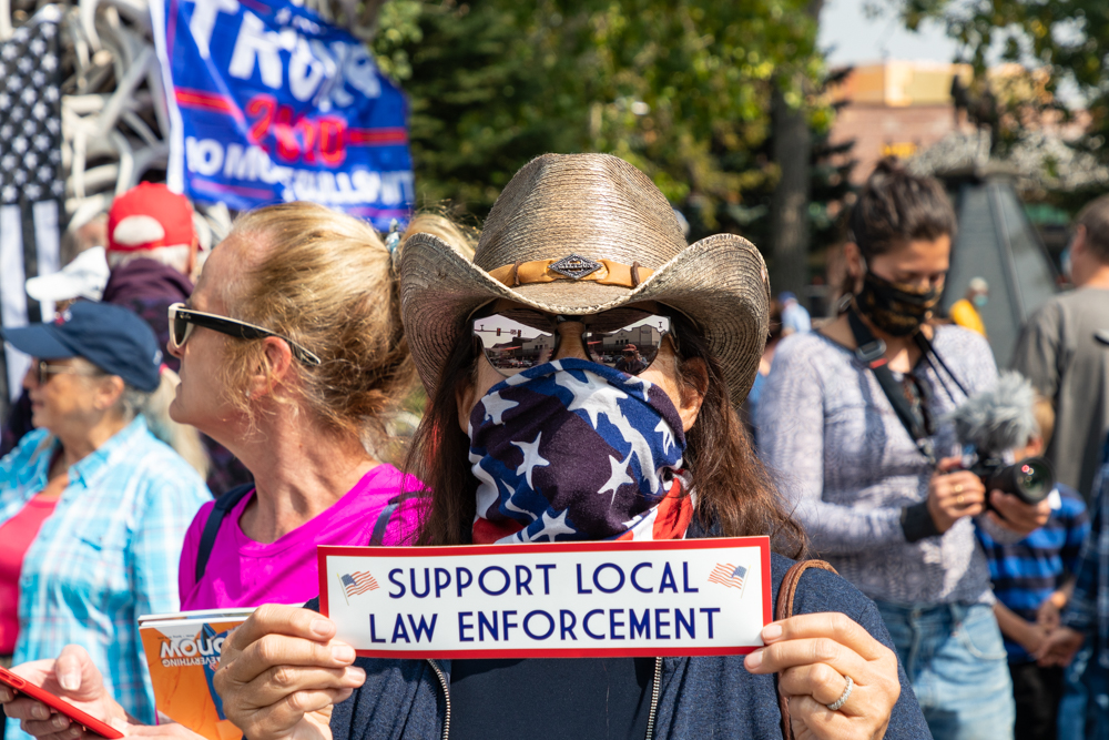 A woman holds a "Support local law enforcement" sticker during a pro-cop rally on Sept. 14 Photo: Joseph Sackett