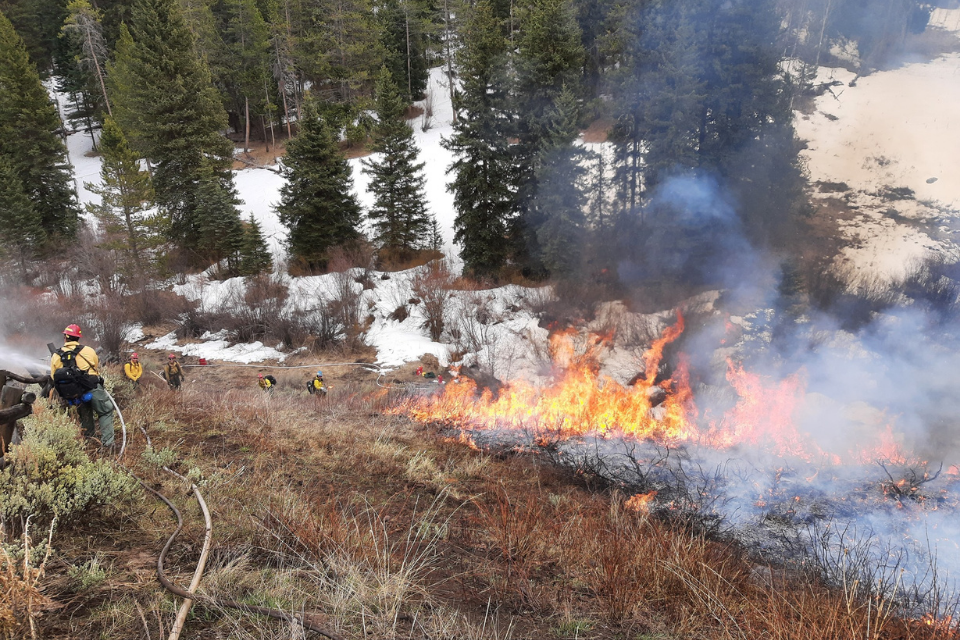 Firefighters manage the burn zone. Photo: EJ Brooks