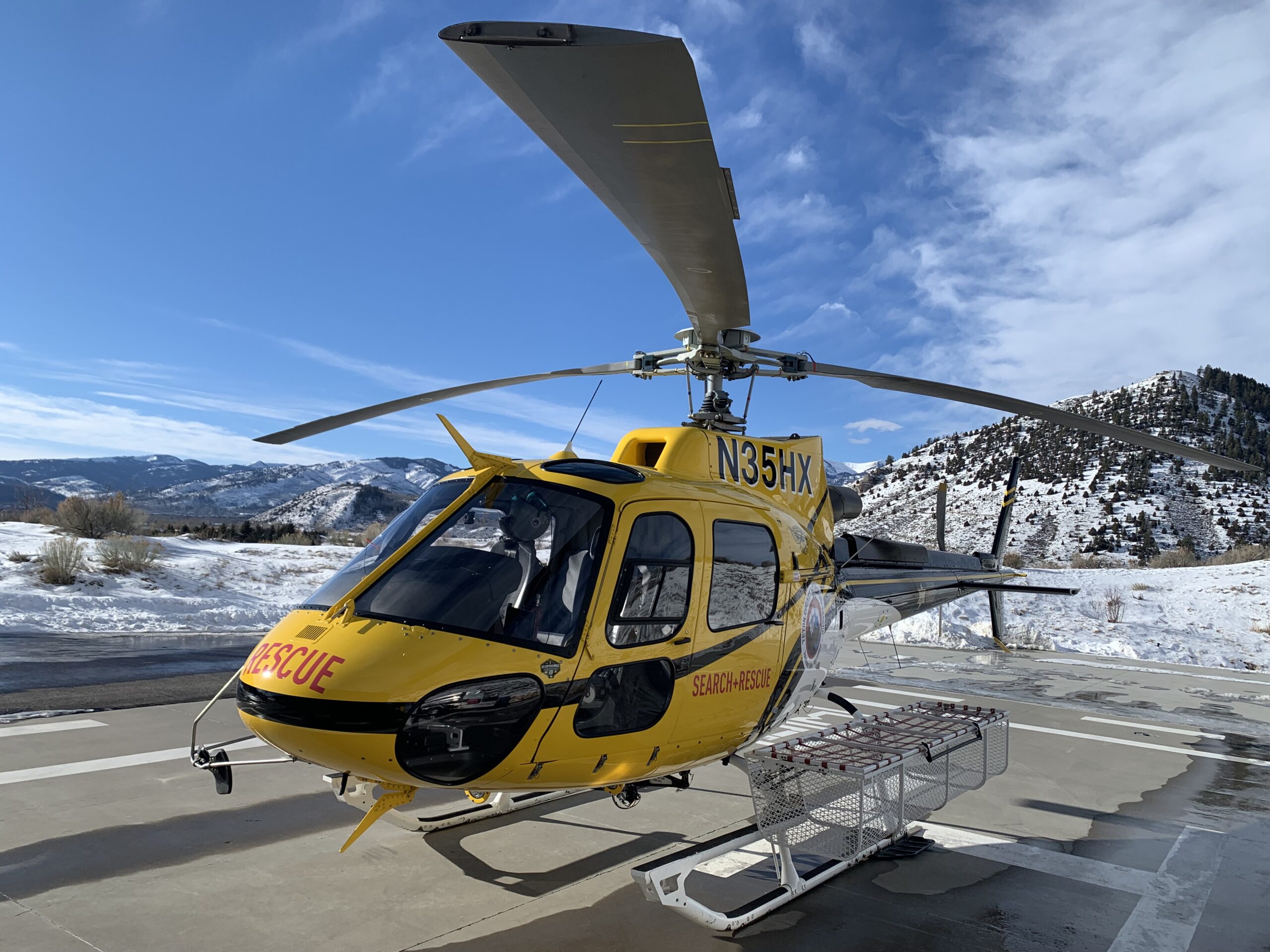Yellow helicopter against a blue sky