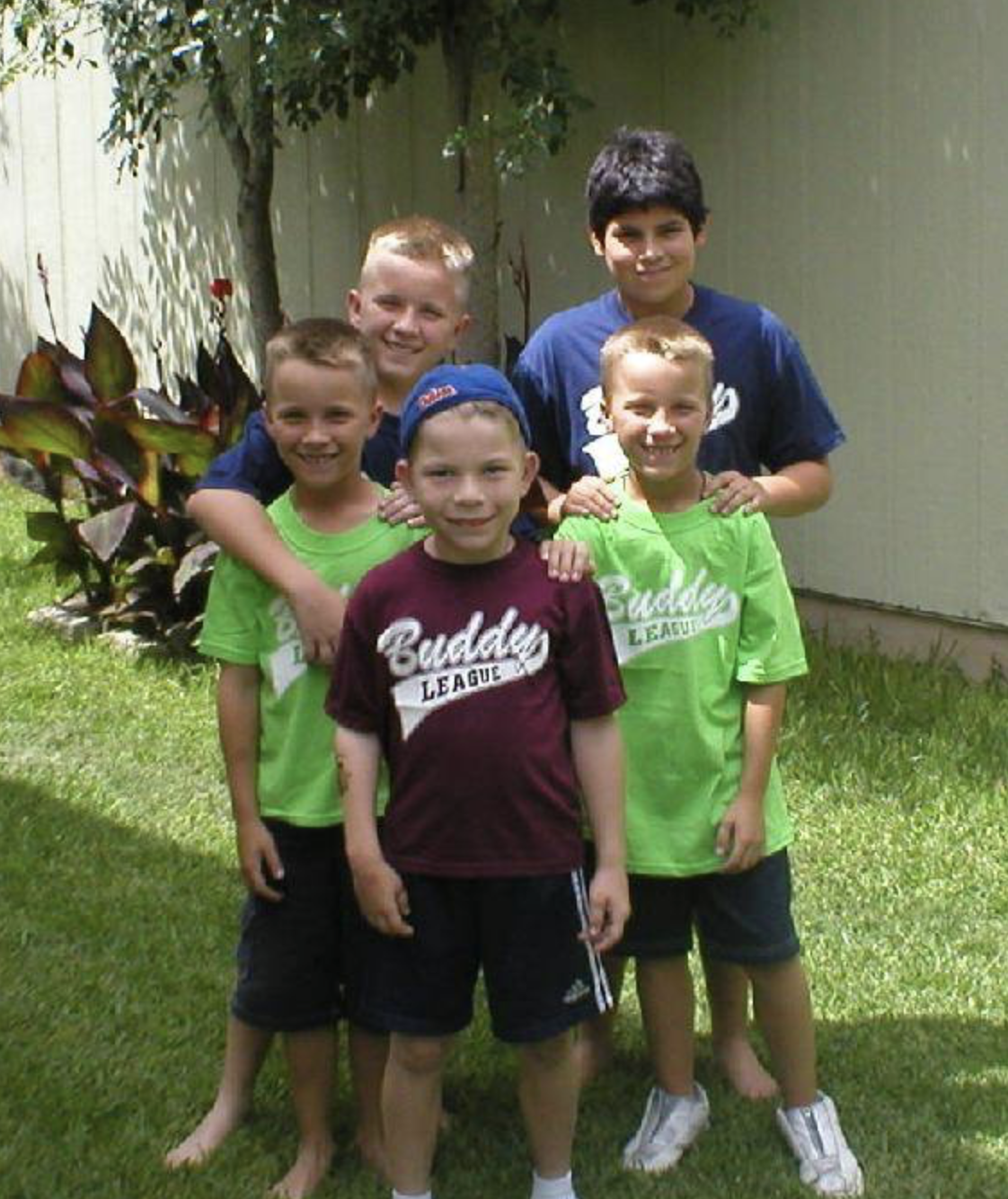 The Millers posing with early Buddy league shirts