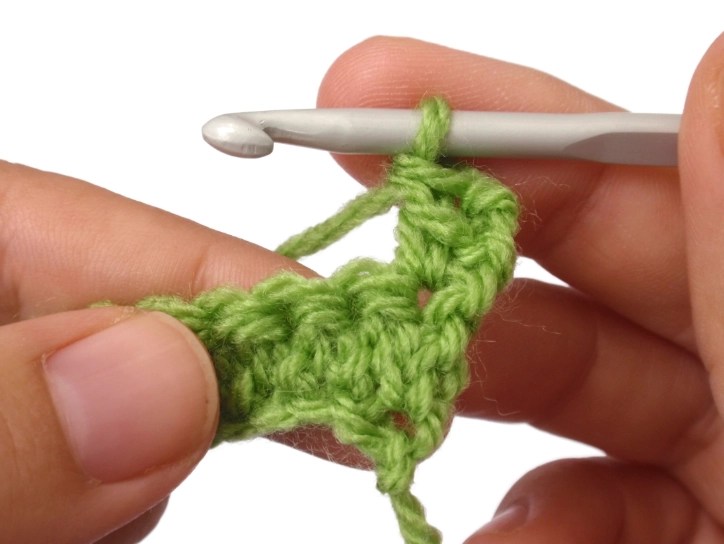 Woman's hands working a linked double crochet