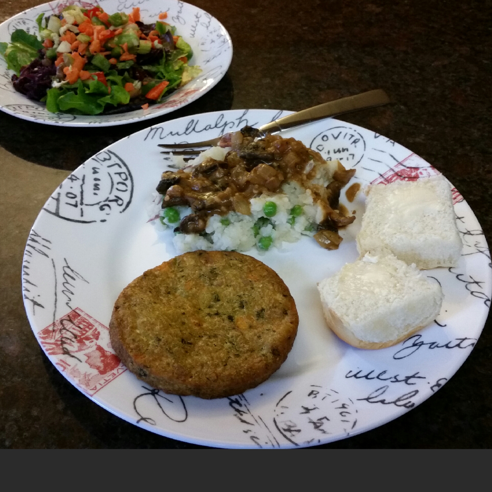 Spring mix salad topped with carrots peppers celery walnuts and dried cranberries with a touch of red cabbage. Veggie burger with a Hawaiian roll and mashed cauliflower, potatoes, and peas topped with a mushroom gravy.