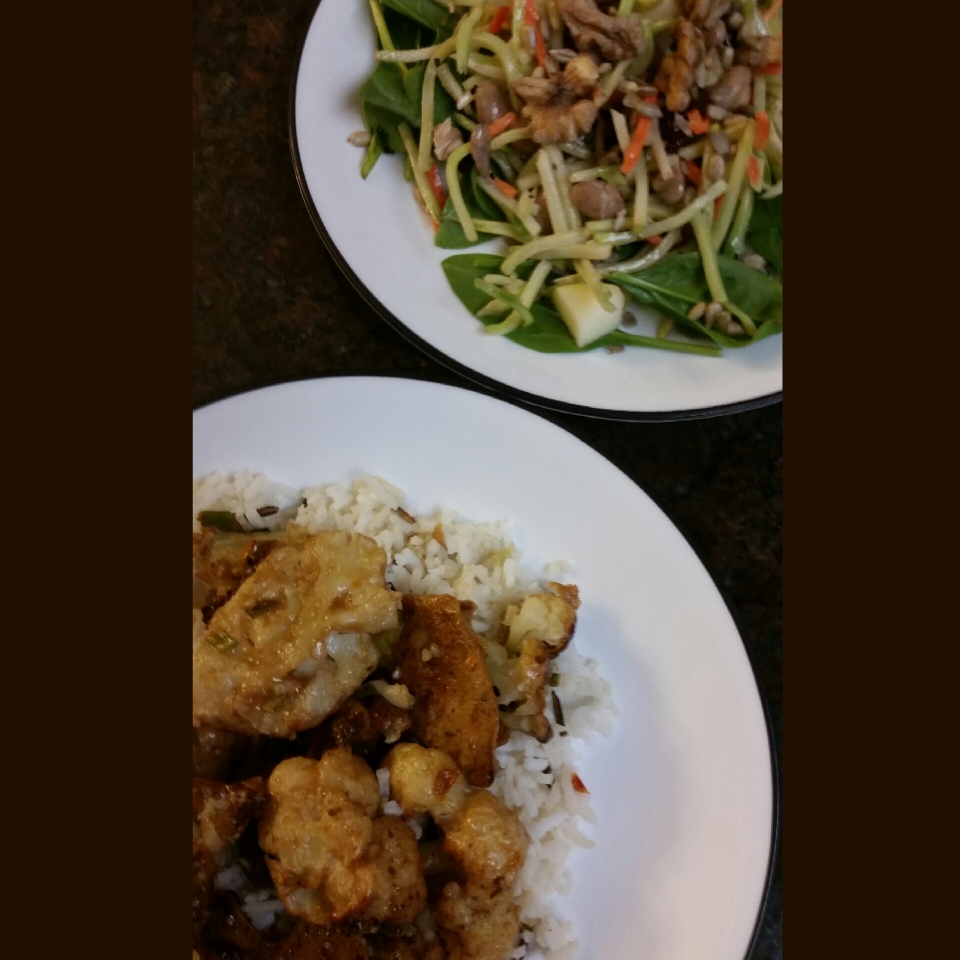 Orange chicken? No, it's Orange cauliflower!! over basmati rice with broccoli slaw topped with apples, dried cranberries, walnuts, and sunflower seeds