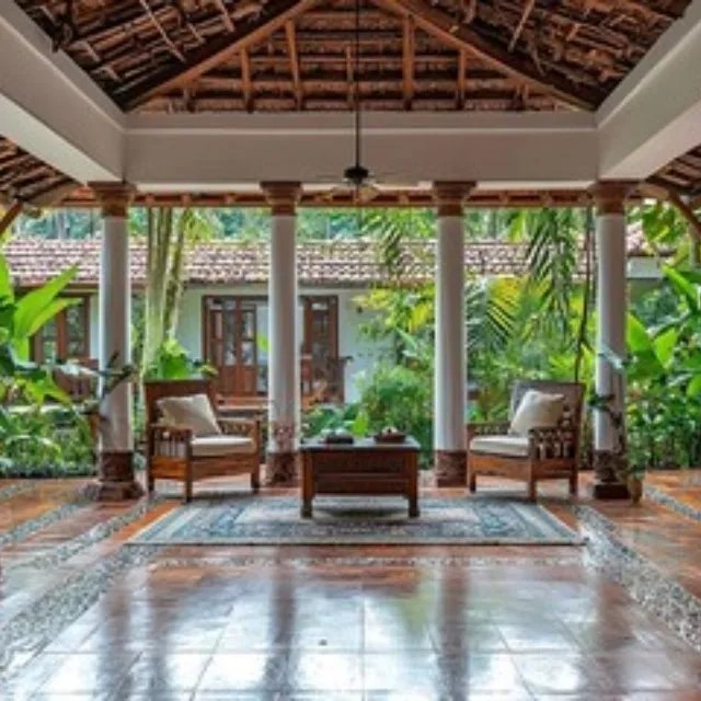 Kerala home interior showcasing wooden finishes, traditional materials, and heritage-inspired design