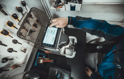 Automotive locksmith helping with a car lockout