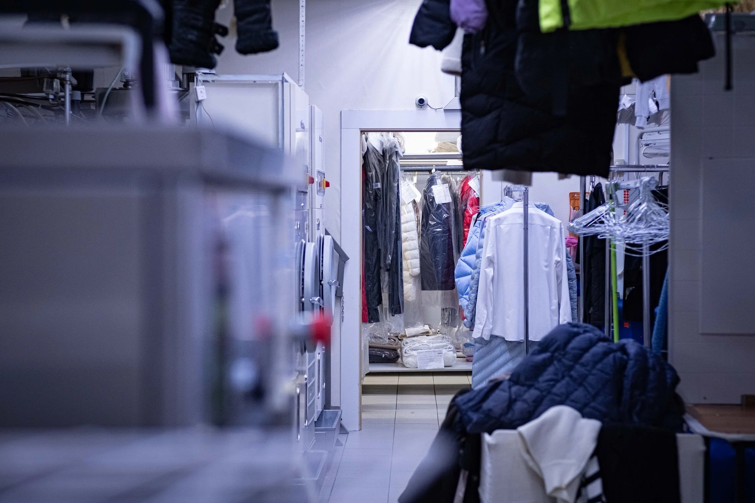 Laundry shop with clothes on hangers
