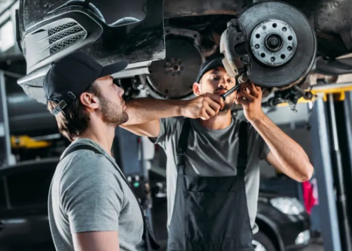 two man repairing brake