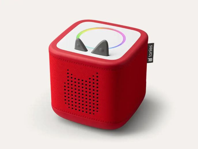 A red Toniebox audio player with playful ears and a colorful circular design on top, designed for children's storytelling.