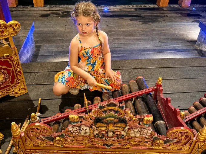 Bali bamboo xylophone-like instrument rindik and kid