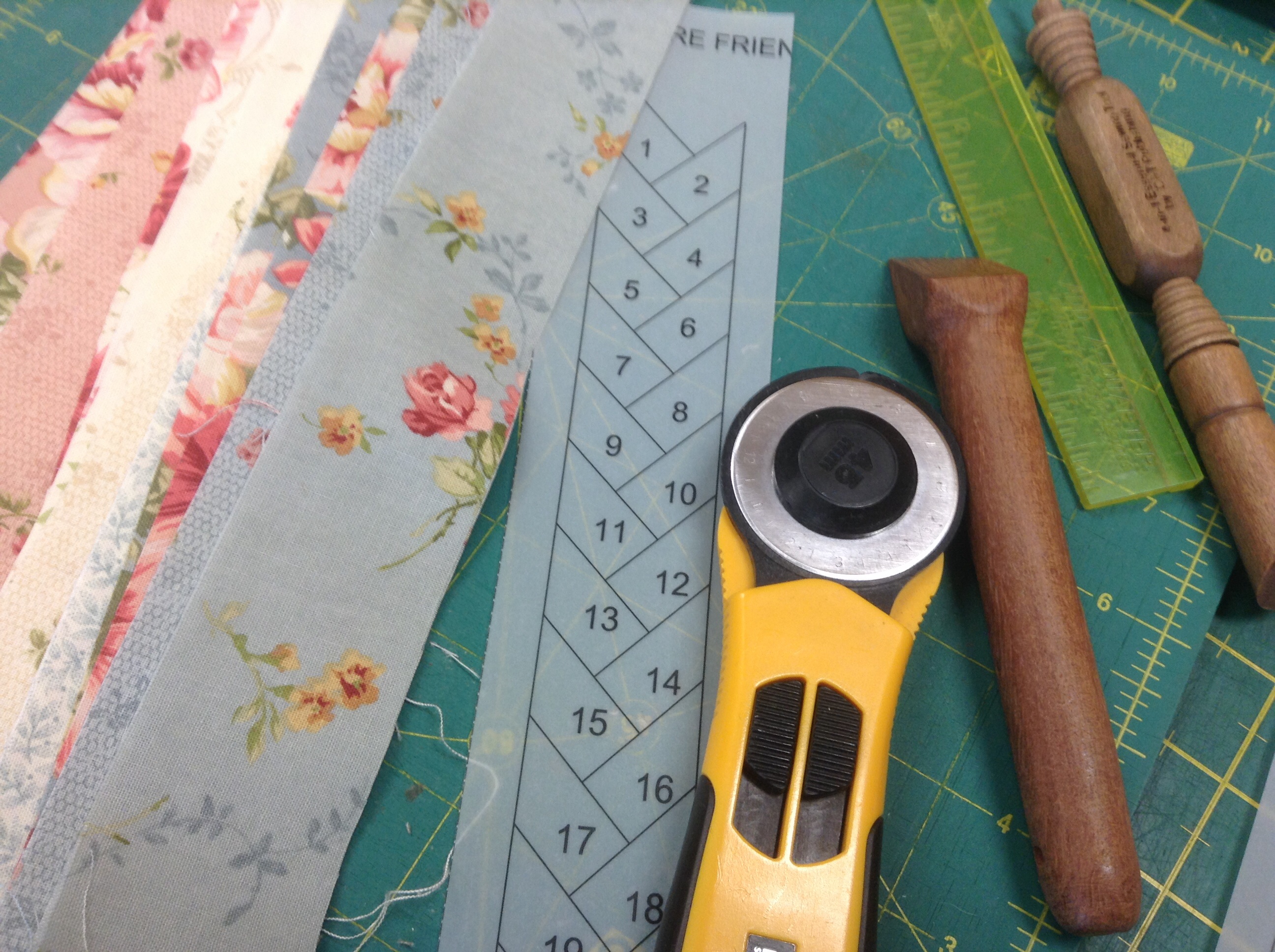 Equipment, fabric, photo stated friendship braid pattern, rotary cutter, seam pressed, quarter inch ruler and rotary cutting board.