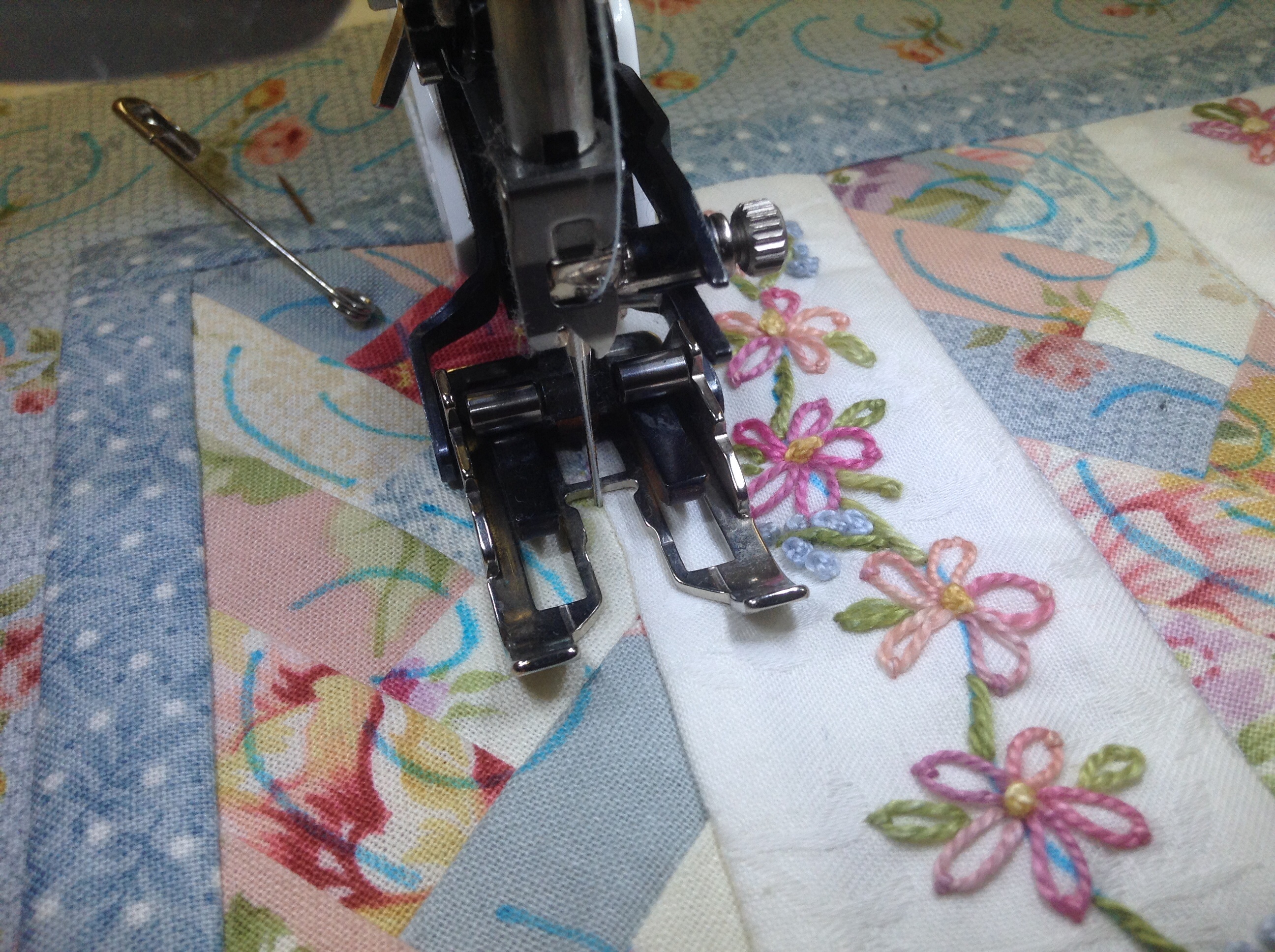 Quilting by stitching in the ditch using a walking foot.