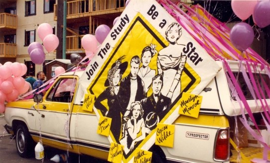 Photo of a car decorated for a parade with a sign saying "Join the study be a star" with drawings of Marilyn Monroe, Oscar Wilde, Billie Holiday, Judy Garland, James Dean, and Mae West.