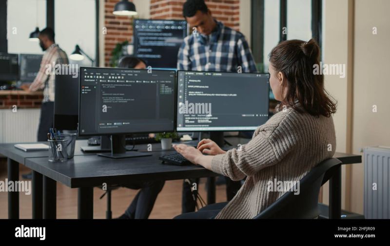 A Focused Software Engineer Writing Code On Multiple Computer Screens - Premium Space Image Gallery - Desktop