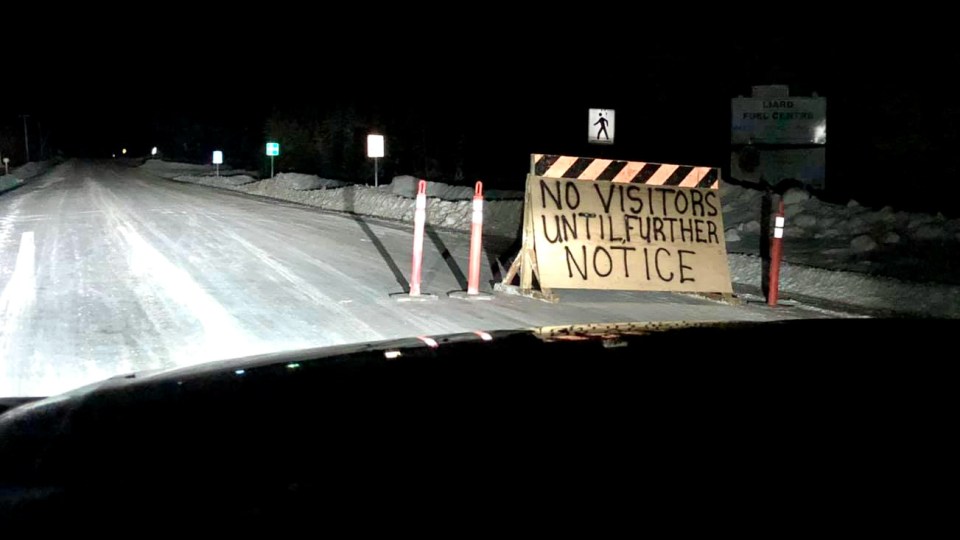 A photo posted to Facebook by Johnneil Bertrand shows a sign placed on the road approaching Fort Liard