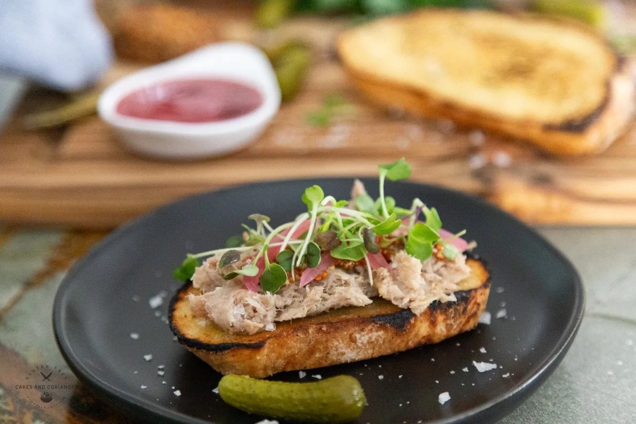 Side view of French Pork Rillette with Pickled Red Onions and micro greens