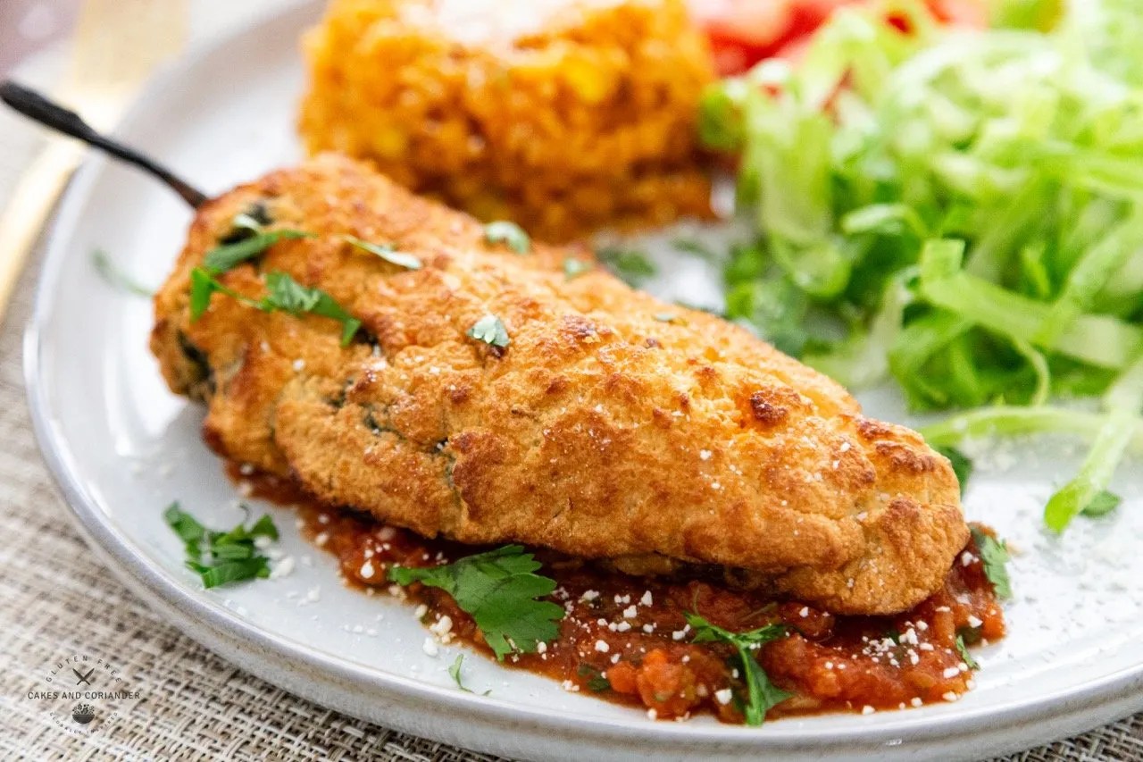Amazing Crispy Battered Air Fryer Chili Rellenos- Gluten Free plated on salsa rojo