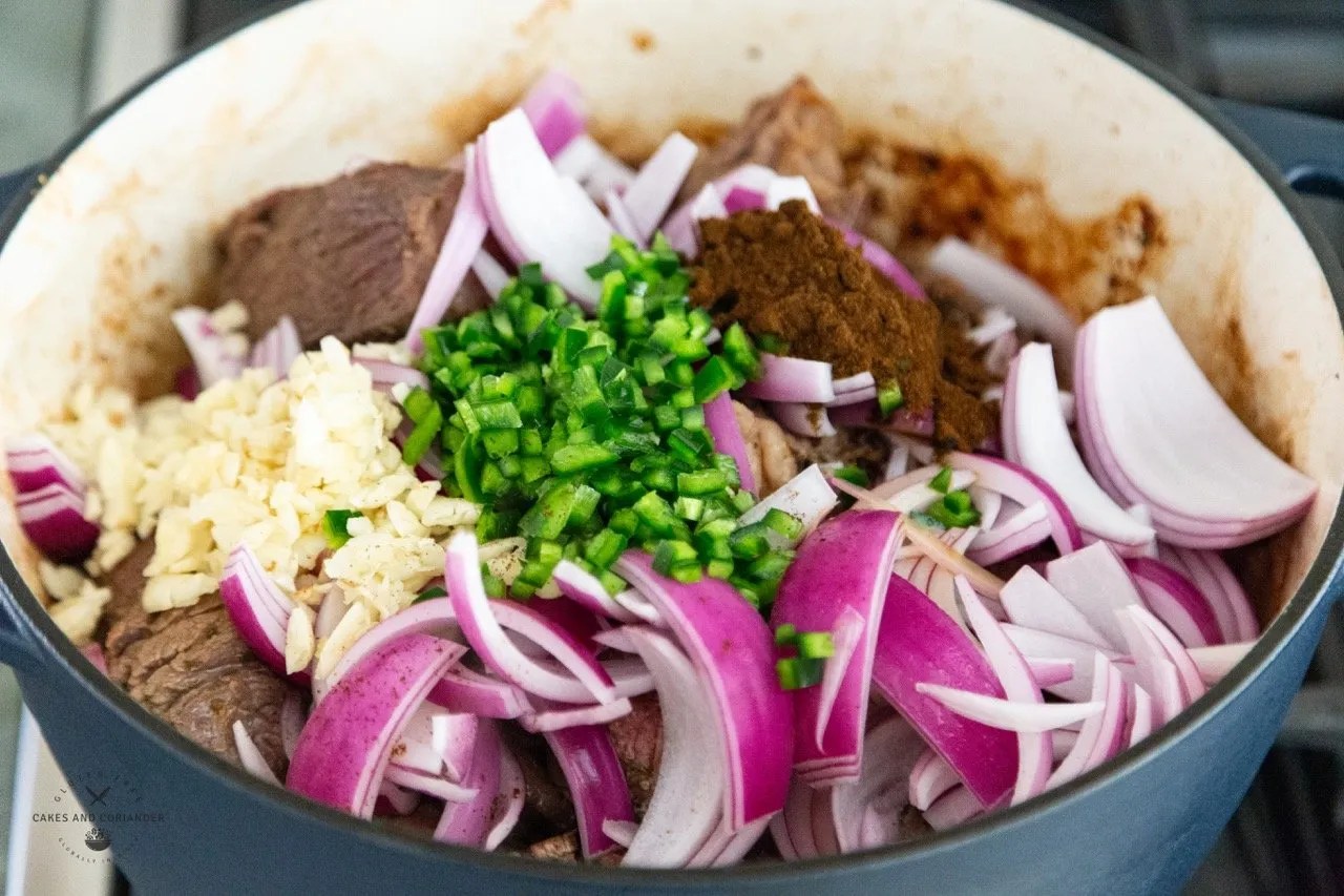 Garlic, Onions, poblano peppers, beef in a dutch oven