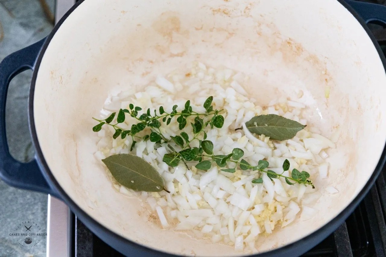 Onion, garlic, bay leaves, oregano in Dutch Oven