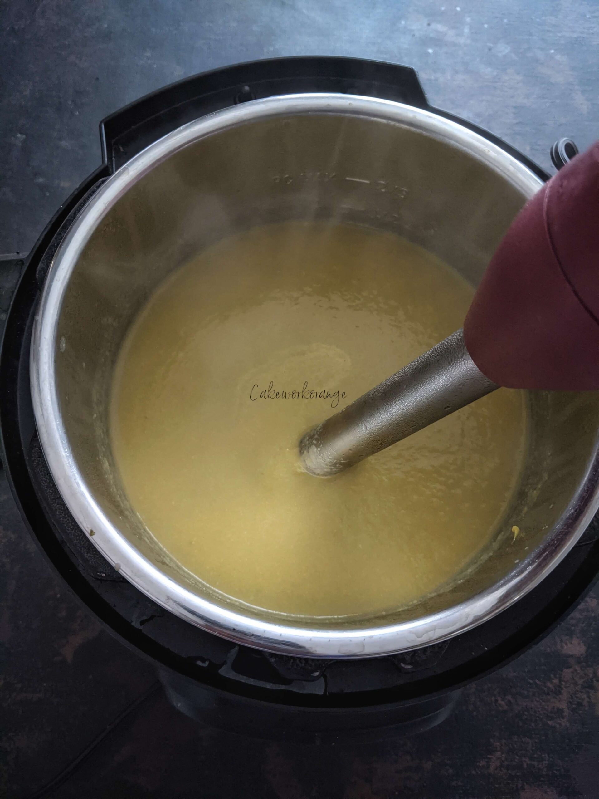 Cooked ingredients of nstant Pot Asparagus Soup blended using an immersion blender