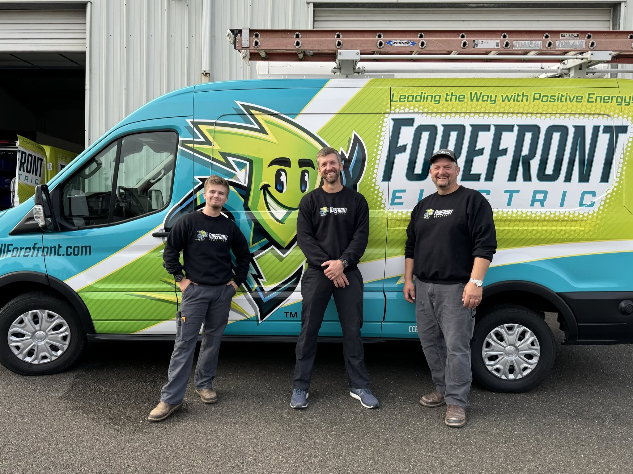 Three electricians standing in front of Forefront Electric van in Eugene, OR