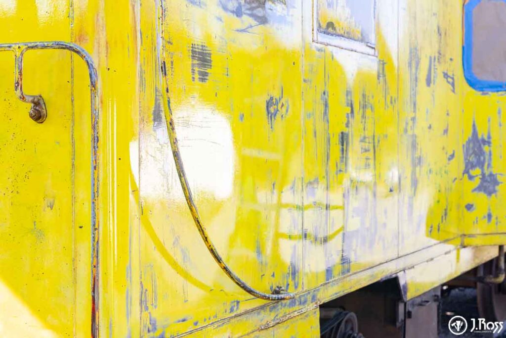 Sheen detail photo after spraying Sherwin-Williams macropoxy on train caboose in Blountville