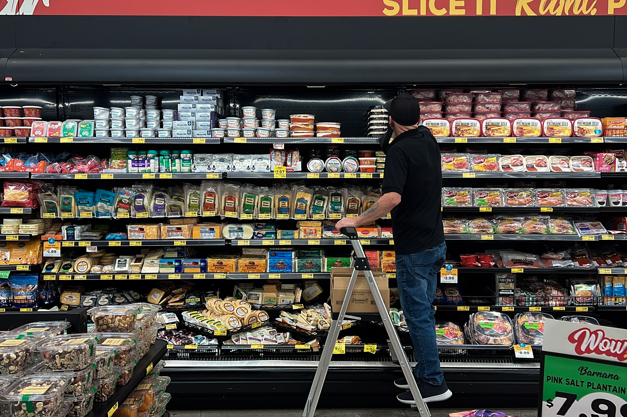 An employee stocks refrigerated items at a Grocery Outlet store in Pleasanton on Sept. 15, 2022. Photo by Terry Chea, AP Photo