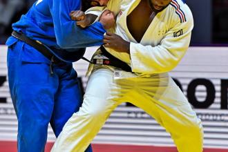 Teddy Riner (R) of France and individual neutral athlete Inal Tasoev compete during the men's +100kg gold medal match at the World Judo Championships in Doha, Qatar on May 13, 2023. (Xinhua/Nikku)
