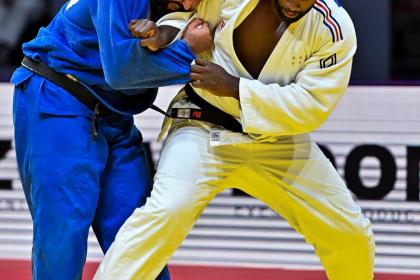 Teddy Riner (R) of France and individual neutral athlete Inal Tasoev compete during the men's +100kg gold medal match at the World Judo Championships in Doha, Qatar on May 13, 2023. (Xinhua/Nikku)