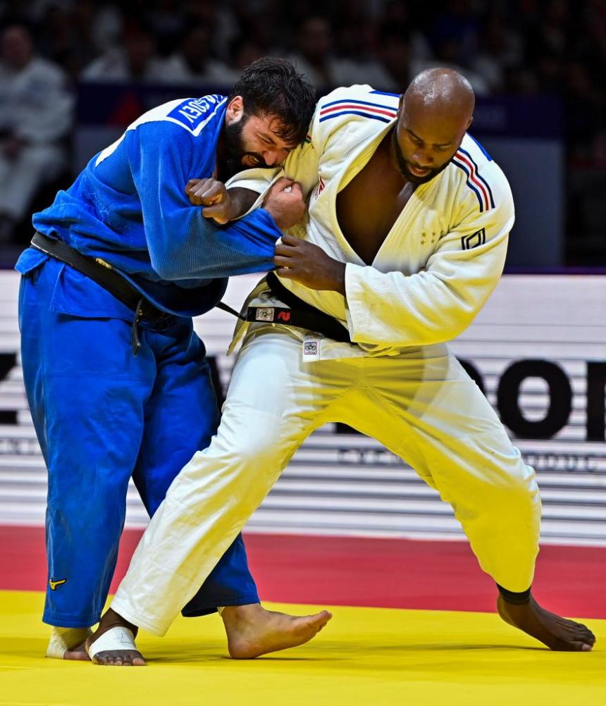 Teddy Riner (R) of France and individual neutral athlete Inal Tasoev compete during the men's +100kg gold medal match at the World Judo Championships in Doha, Qatar on May 13, 2023. (Xinhua/Nikku)