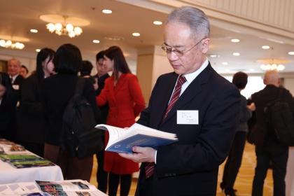 A guest reads the "Promoting the Development and Progress of Human Civilization through Exchange and Mutual Learning" report released by the National High-Level Think Tank of the Xinhua News Agency in Tokyo, Japan, on Feb. 18, 2025. (Xinhua/Jia Haocheng)