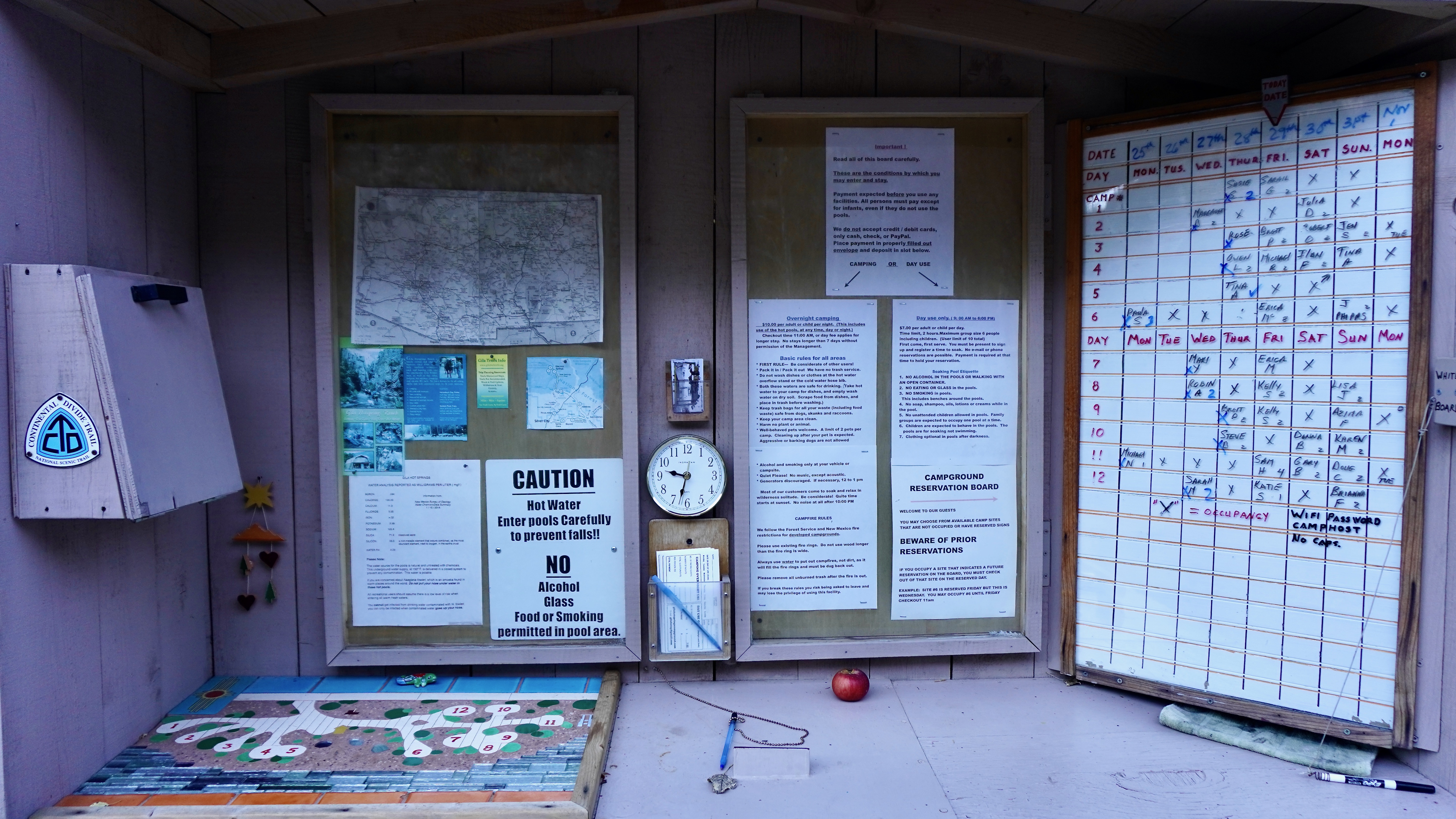 a check in area with schedule map and pages of info about the campground and area