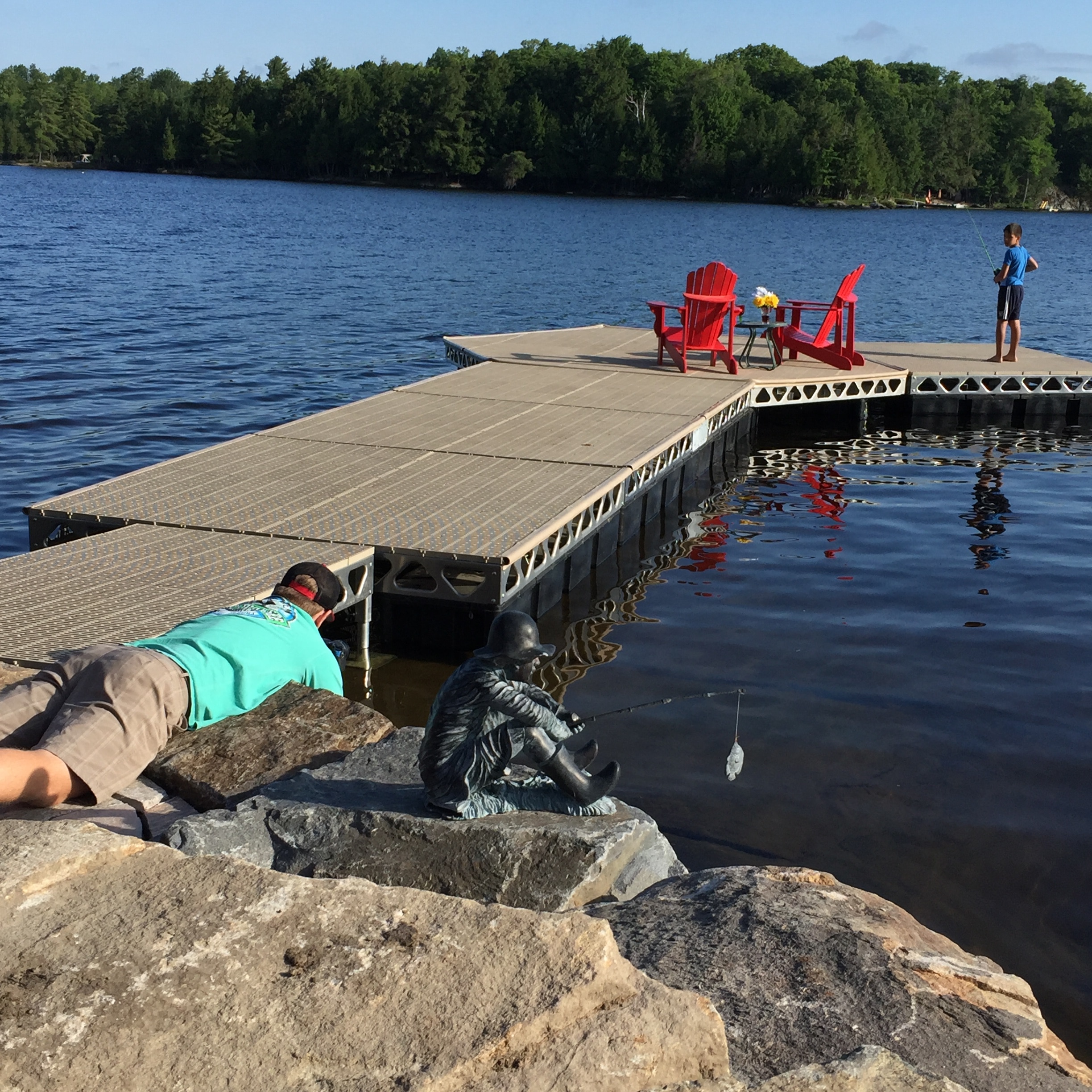 Kid fishing off a CanadaDocks floating hexagon dock