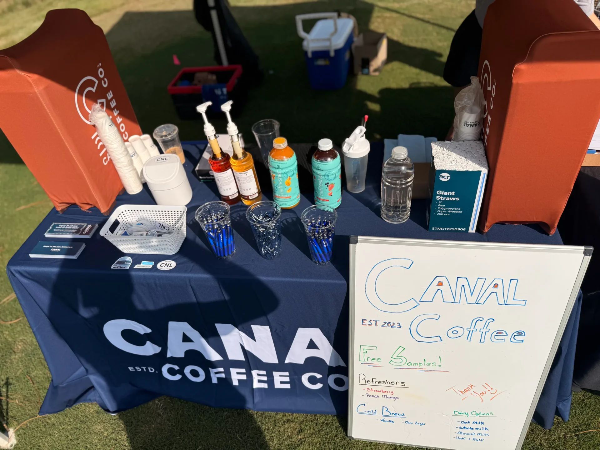 CANAL Coffee Co. outdoor booth with free cold brew samples, refreshers, syrups and branded cups at an event.