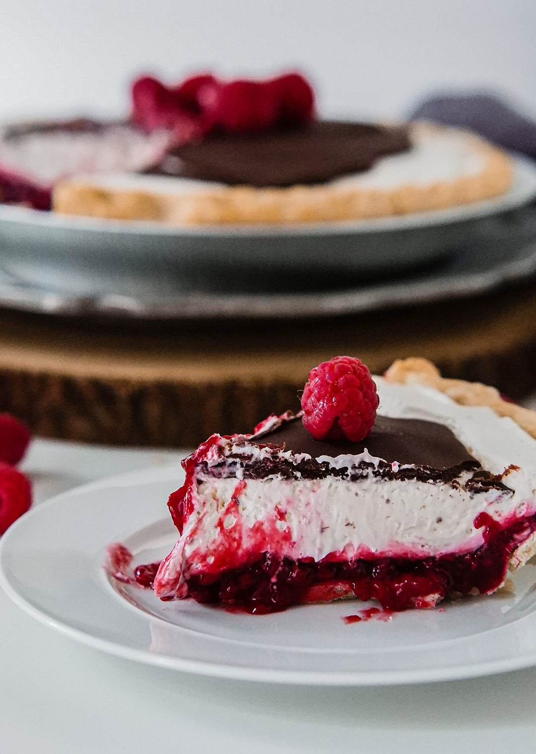 Hey Cutie Pie, Got plans for the first? This Chocolate Raspberry Cream Pie (aka Canada Pie) is perfect for the upcoming national holiday. To my American friends, feel free to borrow it for the fourth, too! A freshly made raspberry jam, a layer of fluffy cream cheese and a chocolate topping create the perfect holiday bite, on a warm summer day.